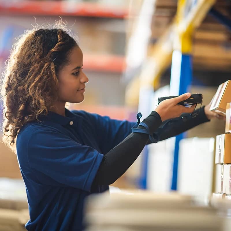 Worker scanning box in warehouse.