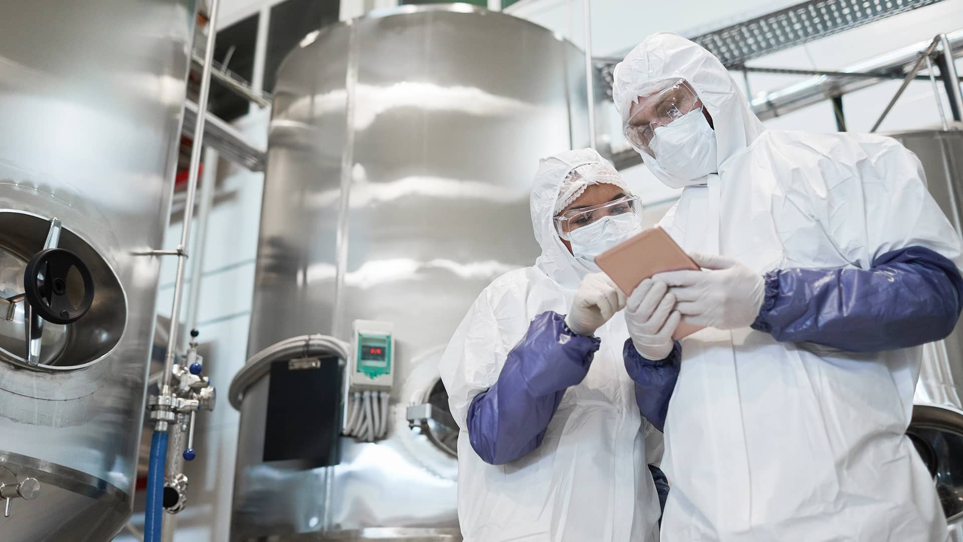 Two workers of a pharmaceutical company prepare load for shipping.