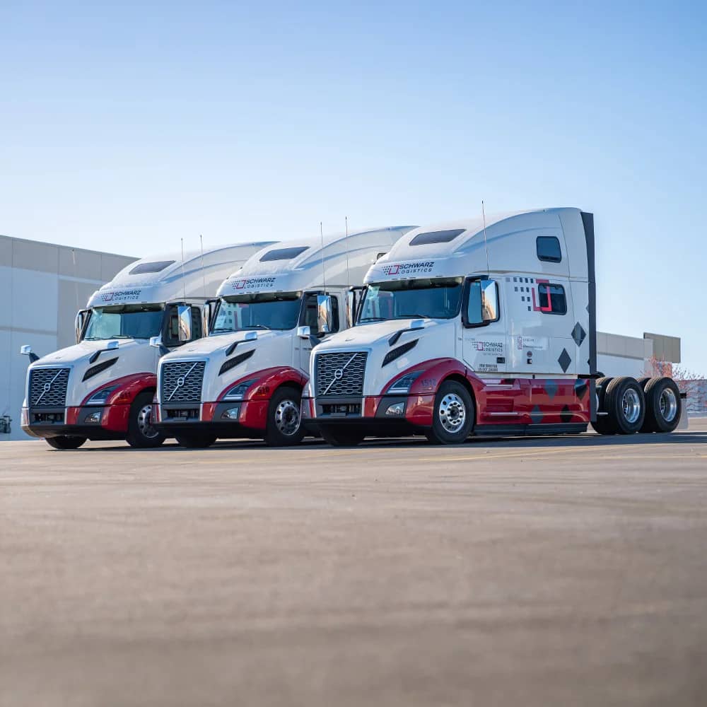 Volvo trucks with Schwarz Logistics branding on them