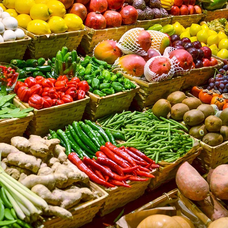 A colorful display of various fresh vegetables and fruits at a market.