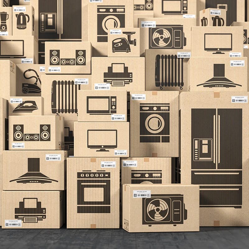 Cardboard boxes with black line drawings of various household appliances, stacked, ready for shipping or storage, symbolizing consumer electronics distribution.